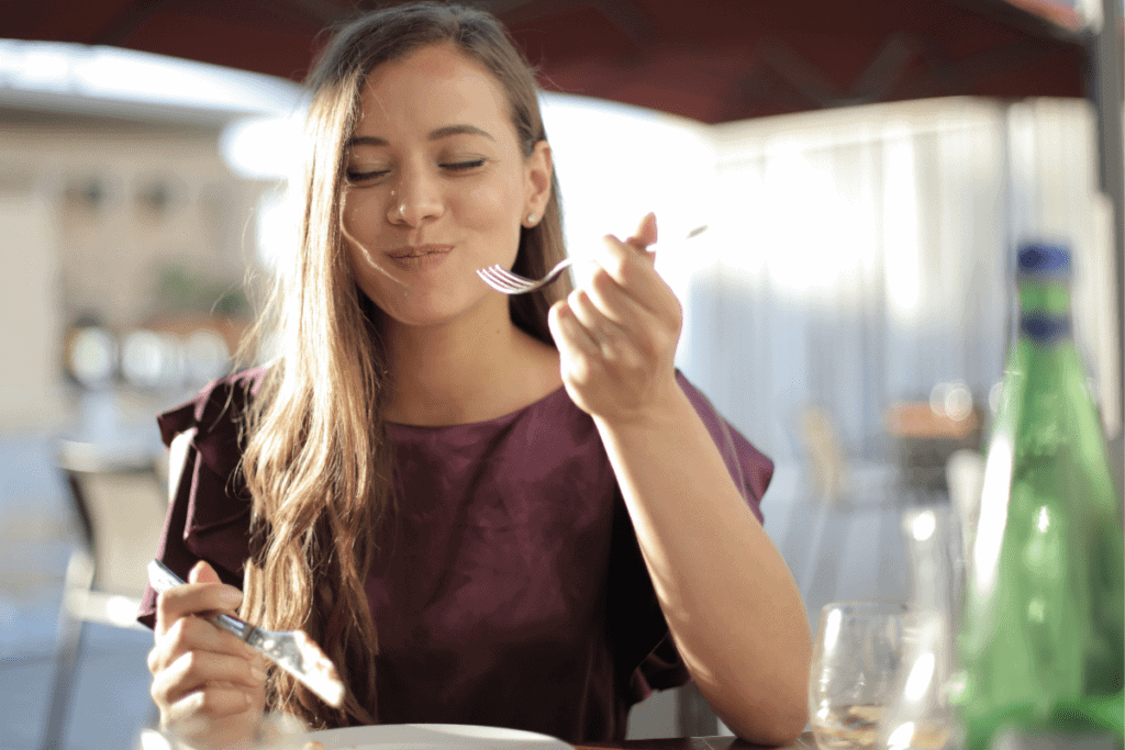 woman eating with fork and knife