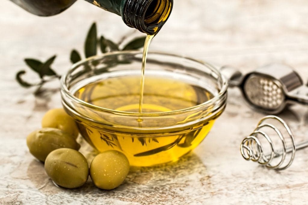 Pouring Olive Oil and olives