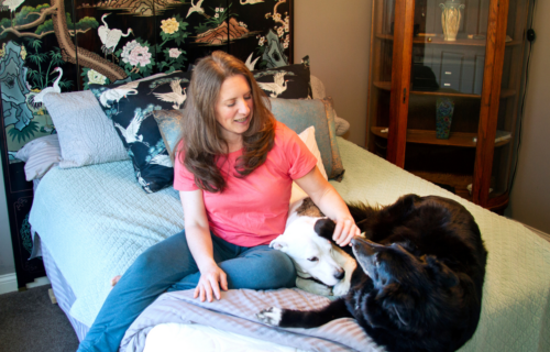 Beth on non toxic mattress with dogs