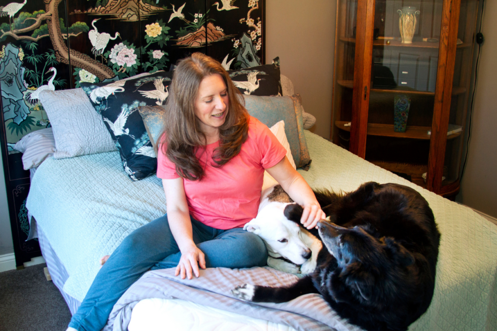 Beth on non toxic mattress with dogs