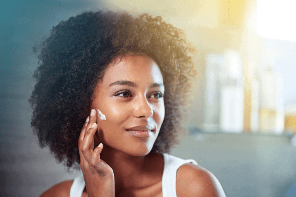woman putting lotion on face