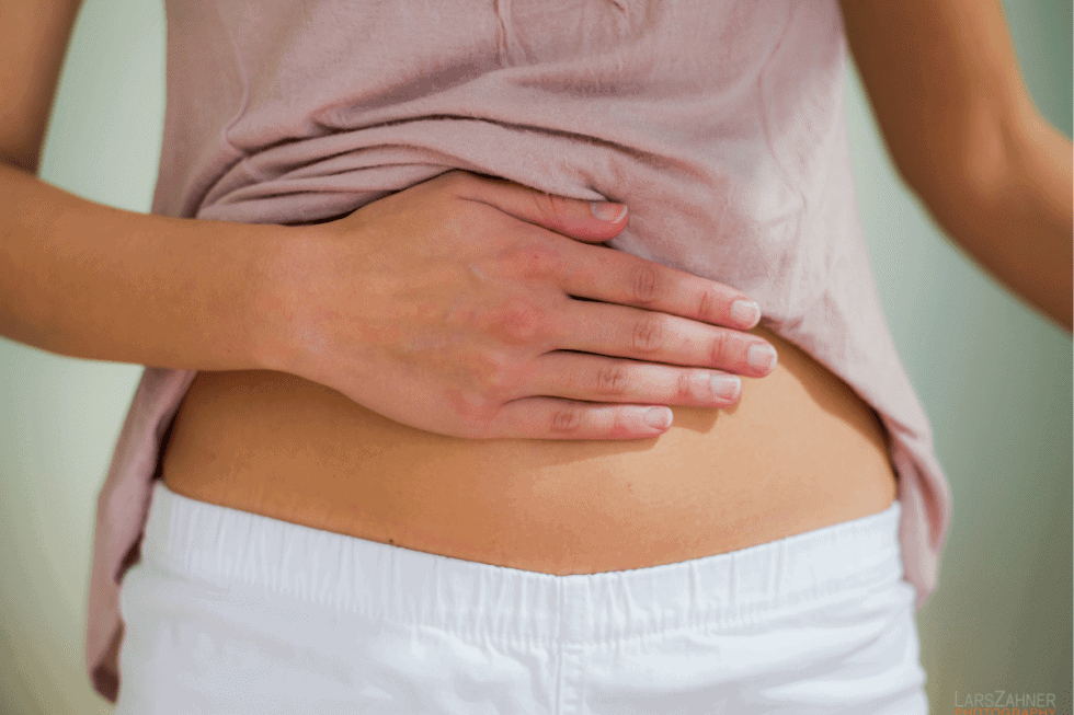 woman holding upset tummy