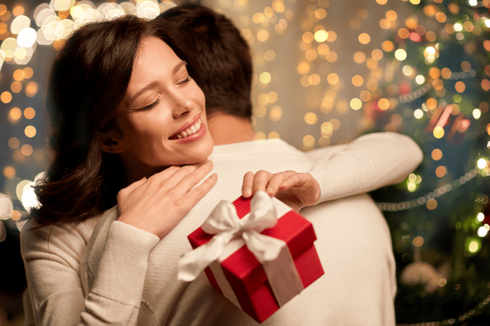 woman with gift hugging man