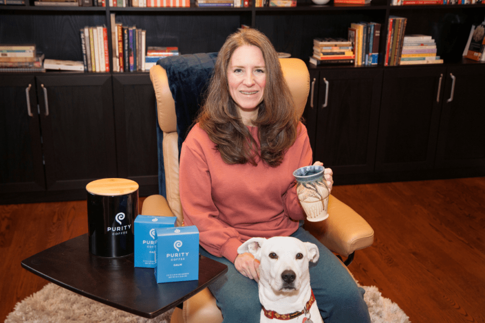 Beth holding low histamine coffee, mold free coffee by purity coffee