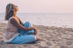 Woman sitting on the beach - Relaxing