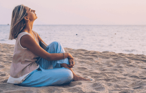 Woman sitting on the beach - Relaxing