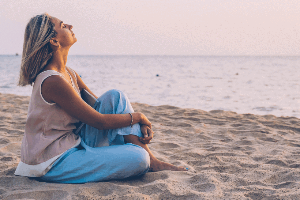 Woman sitting on the beach - Relaxing